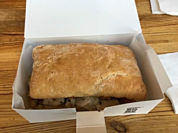 Meat & Bread's signature Porchetta sandwich to go.