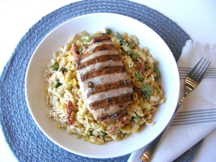 The Rodeo Season: Grilled chicken ‘Mac & Cheese’ (sauce: coconut milk, vegetable stock, spices, tapioca flour, nutritional yeast, vegan pea protein butter, garlic) with sun-dried tomatoes, artichokes & asparagus over gluten free pasta with crispy organic gluten free panko.