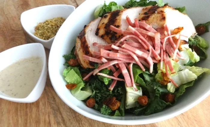 The Policia Fashionista: grilled chicken, oven roasted turkey back bacon, tossed in romaine and kale, with creamy, dairy free Caesar dressing, turmeric spiced crispy chickpea croutons, and walnut-hemp parmesan.