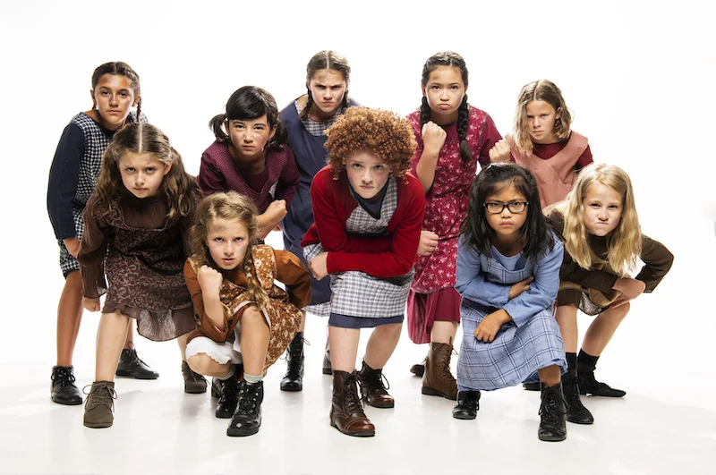 Camryn Macdonald (centre) with the company of Annie. Photo credit: Emily Cooper