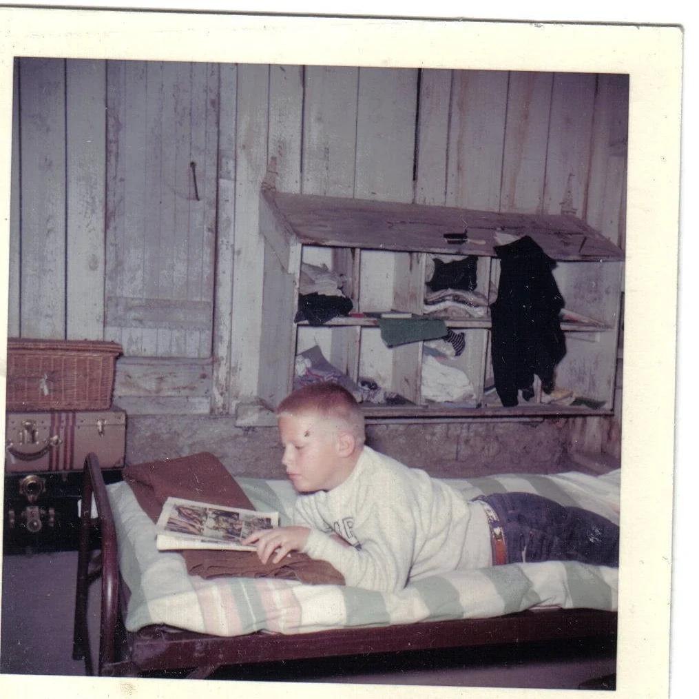 ca. 1959: Rest hour in the old boys’ bunkhouse, (a renovated chicken house – note the nesting boxes converted into cubbys) By the way, this camper is now the parent of three JE former campers and staff members: Nate, Sam and Molly Sherwood.