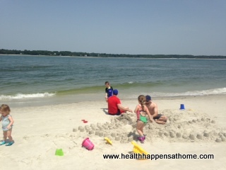  my kids building sandcastles with daddy and uncle