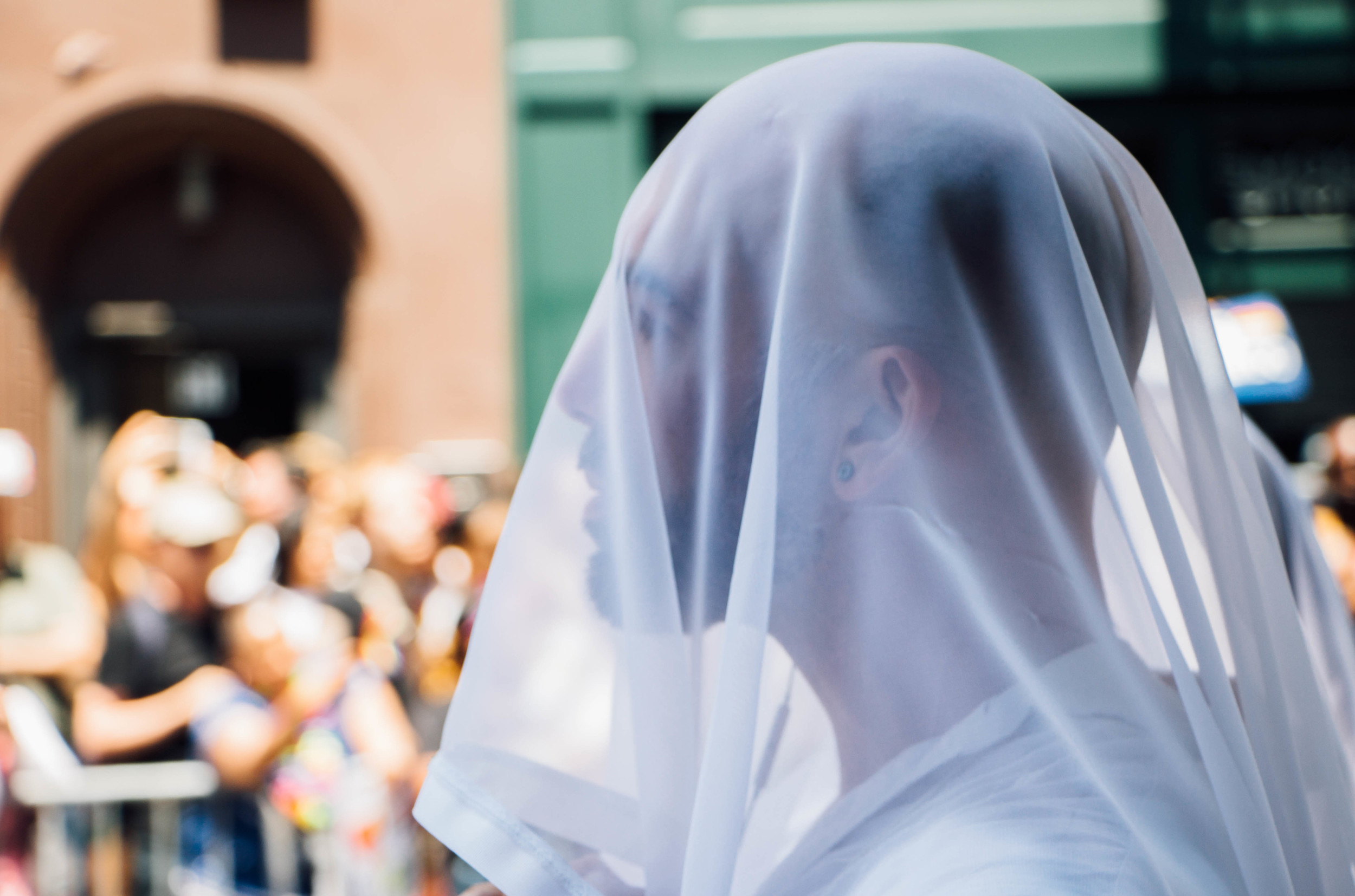 One group dressed in all white with veils covering their faces.