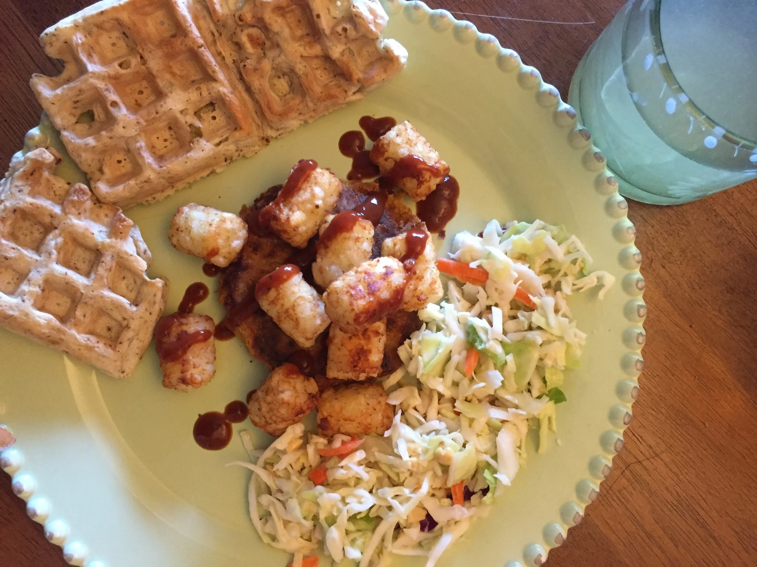 The patty is a little hard to see. But here I ate it with the coleslaw I featured last week, tater-tots, and the savory waffles from my vegan "chicken" & waffles recipe a while back. Drizzled with barbecue sauce and ketchup and a glass of homemade lemonade to drink!