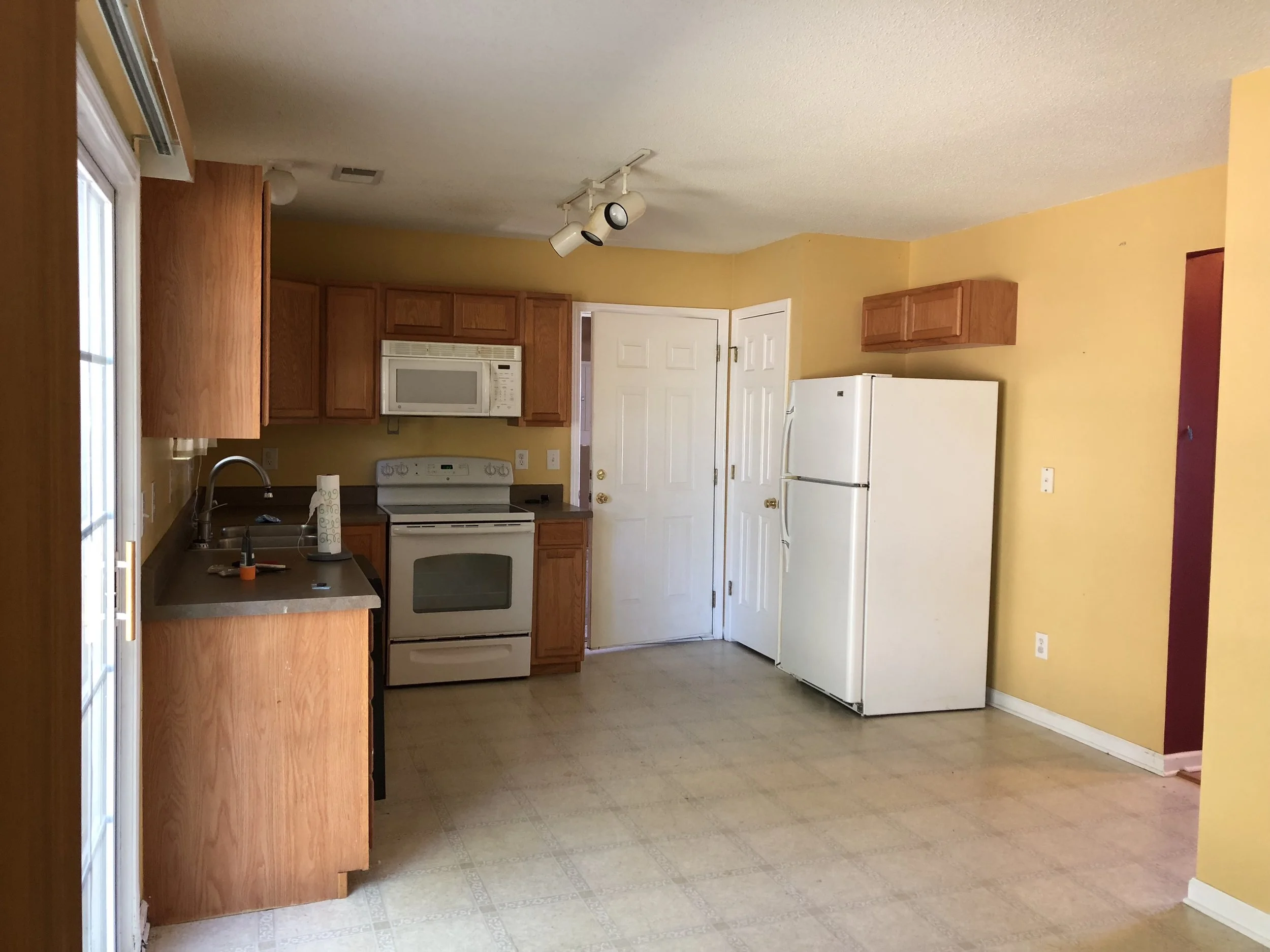 This is our tiny but yet functional little kitchen. Kyle added new cabinets on the right side, evens out the kitchens and gives us more cabinet space. My amazing and talented mother painted all the cabinets and counter tops, since it was no longer in the budget to change those out.
