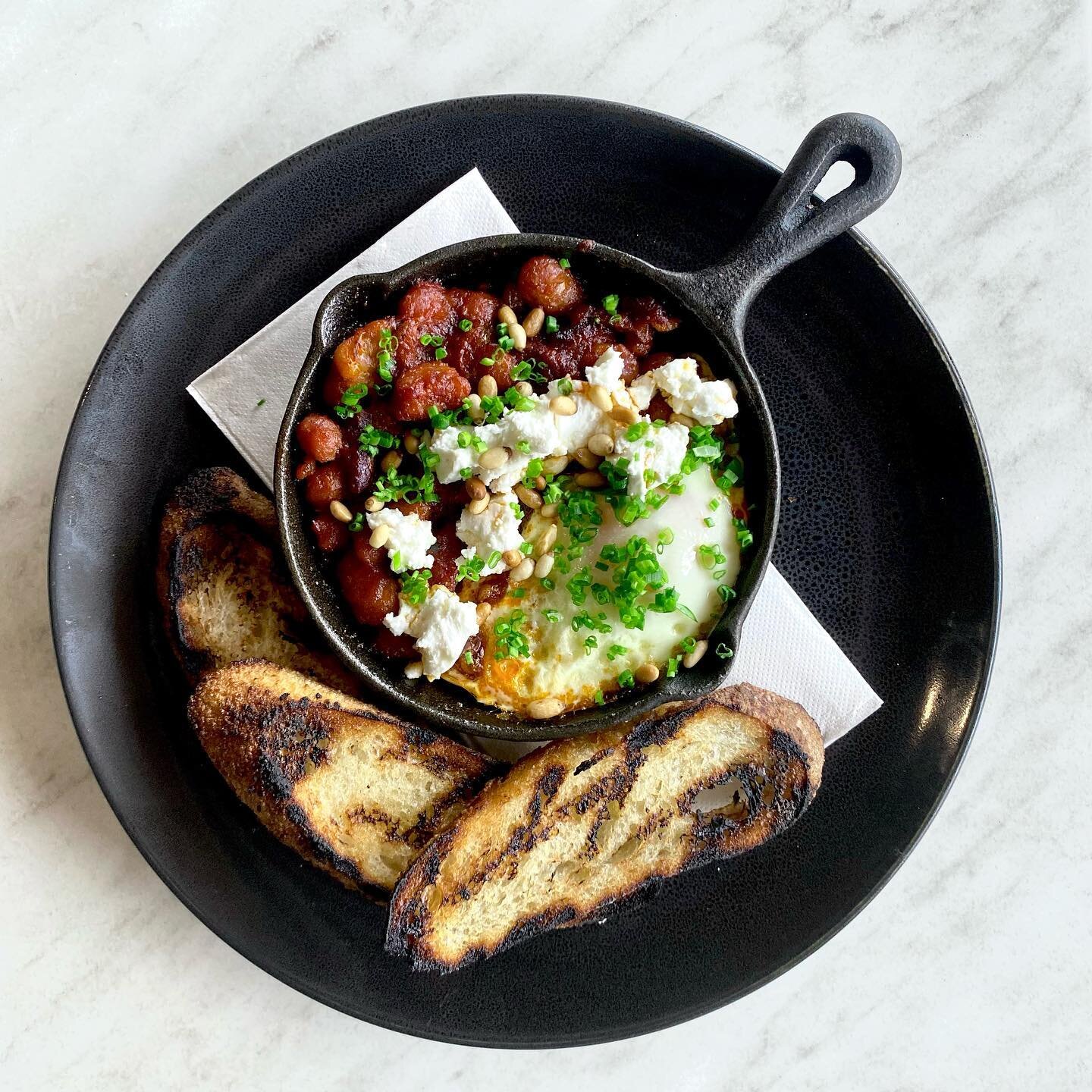 Our Baked Eggs are a sure fire way to warm you up on these cold winter mornings - with Chorizo, beans, tomato &amp; feta served with toasted baguette it&rsquo;s definitely a crowd favourite 🤤