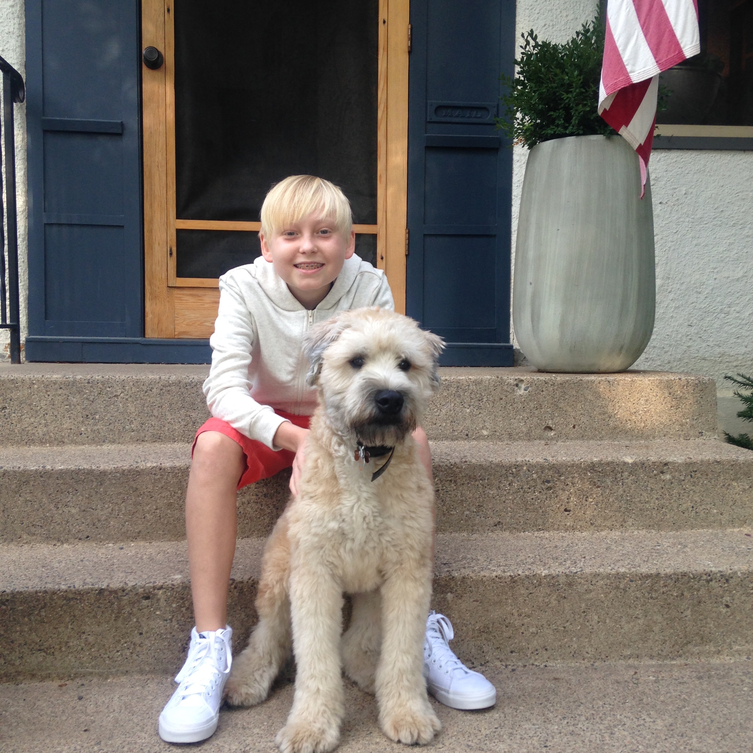Saunder during treatment, posing with the family dog at home.
