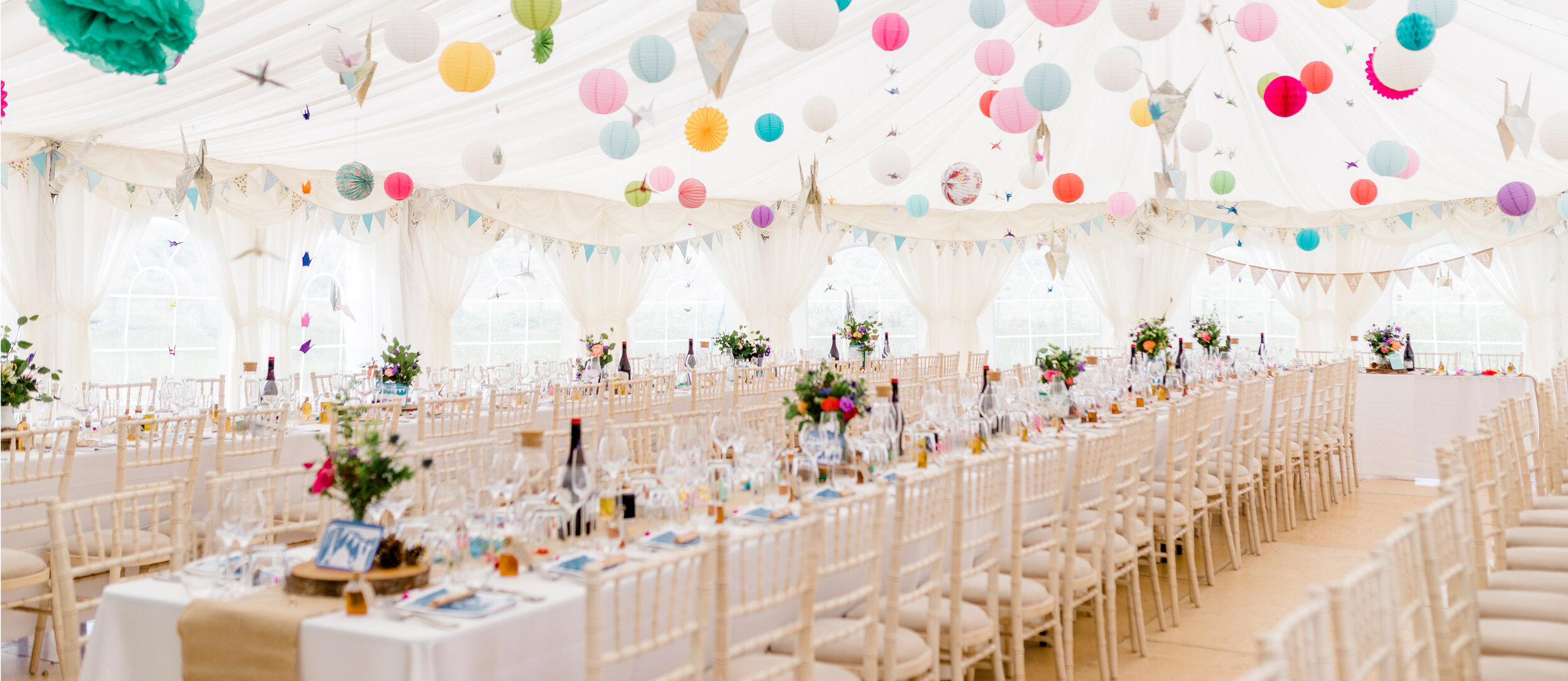 Rustic DIY wedding table layout with colourful lanterns at Harvest Moon in East Lothian, Scotland