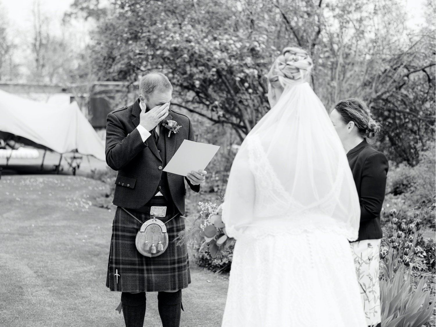 17_groom reading his vows during ceremony at leuchie walled garden near north berwick east lothian scotland.jpg