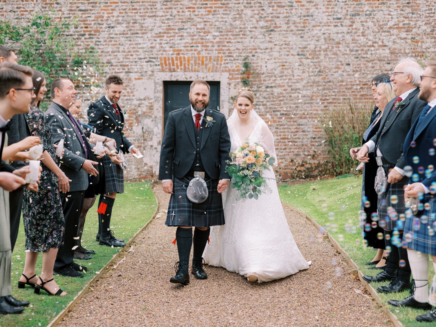 24_bride and groom with confetti at leuchie walled garden near north berwick east lothian scotland.jpg