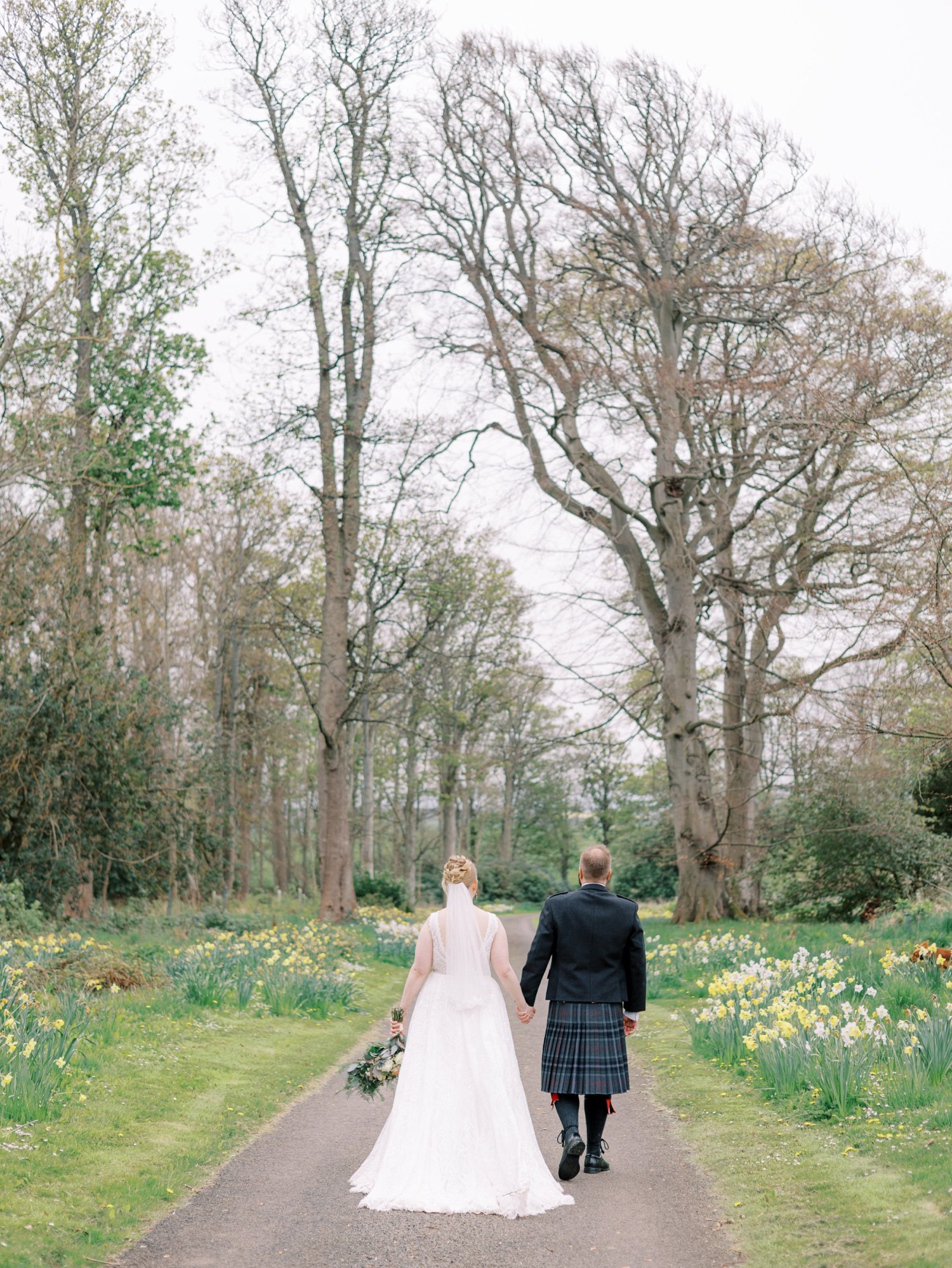 38_bride and groom walking away at leuchie walled garden near north berwick east lothian scotland.jpg