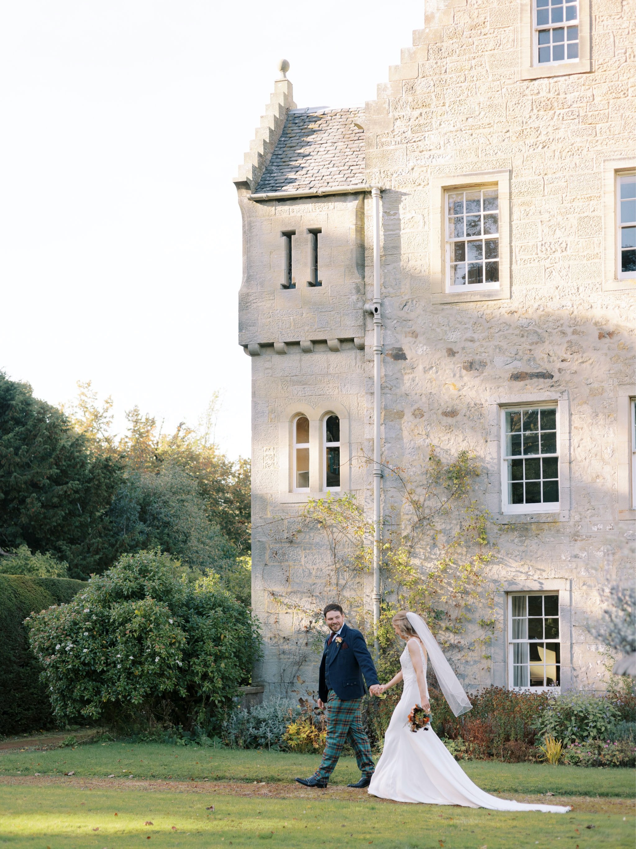 31_wedding photographer kirknewton house stables edinburgh walking together.jpg