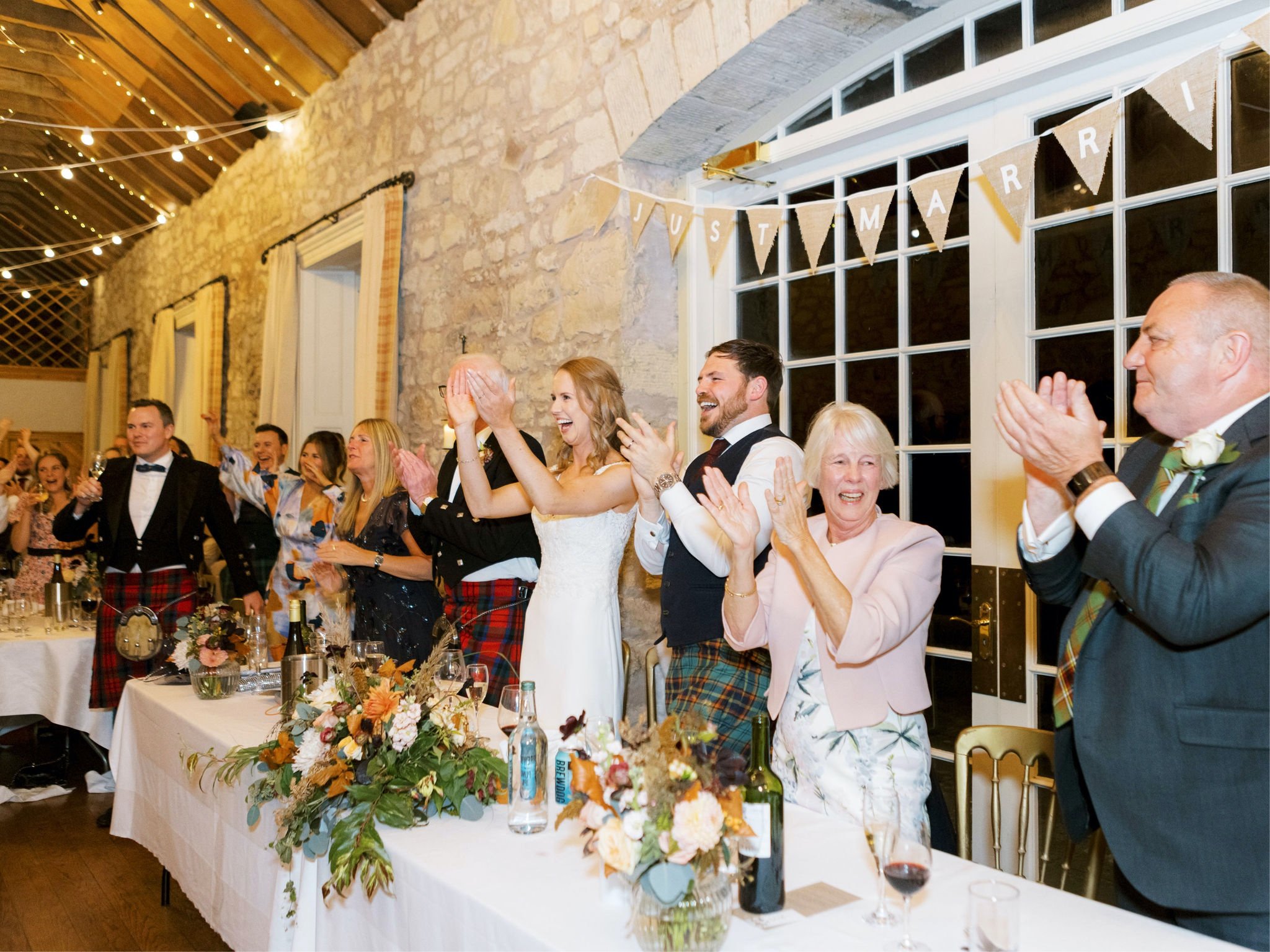 47_wedding photographer kirknewton house stables edinburgh bride and groom clapping.jpg
