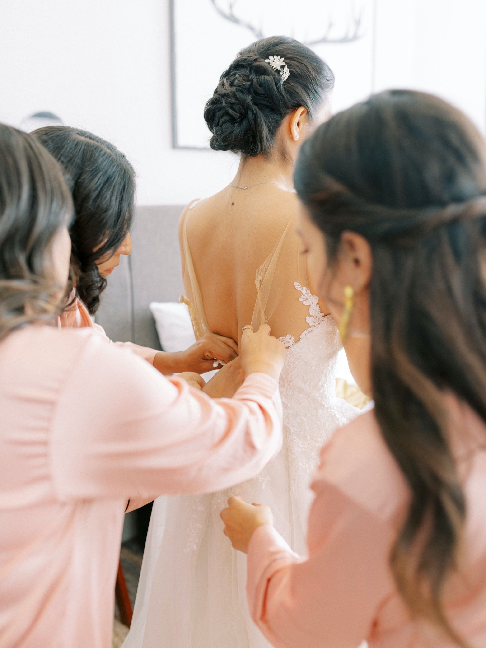 07_edinburgh wedding photographer bridesmaids helping bride into dress .jpg