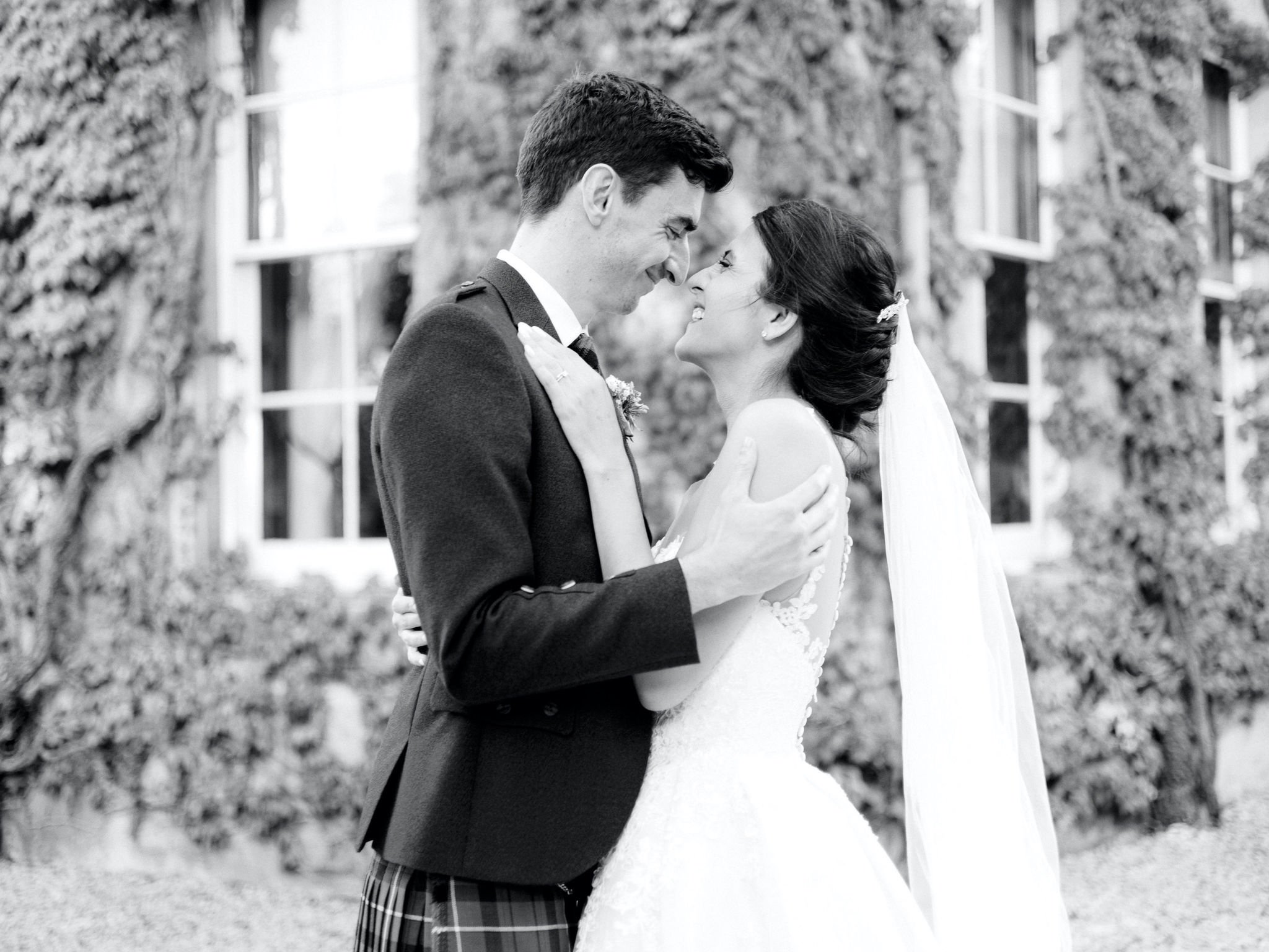 26_carlowrie castle edinburgh wedding photographer bride and groom laughing together.jpg