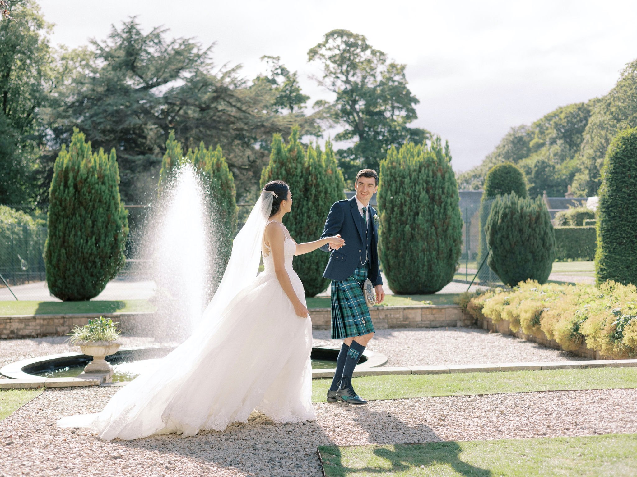 28_carlowrie castle edinburgh wedding photographer bride and groom exploring the grounds.jpg