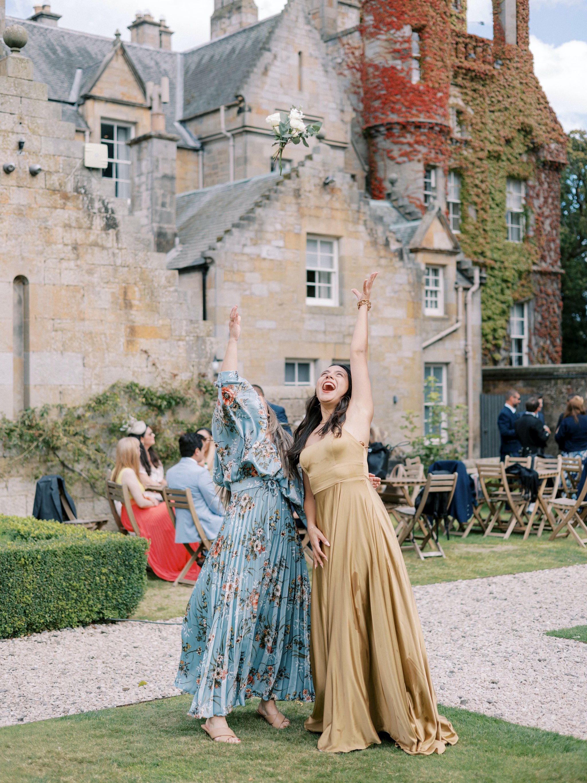 39_carlowrie castle edinburgh wedding photographer throwing the bouquet.jpg