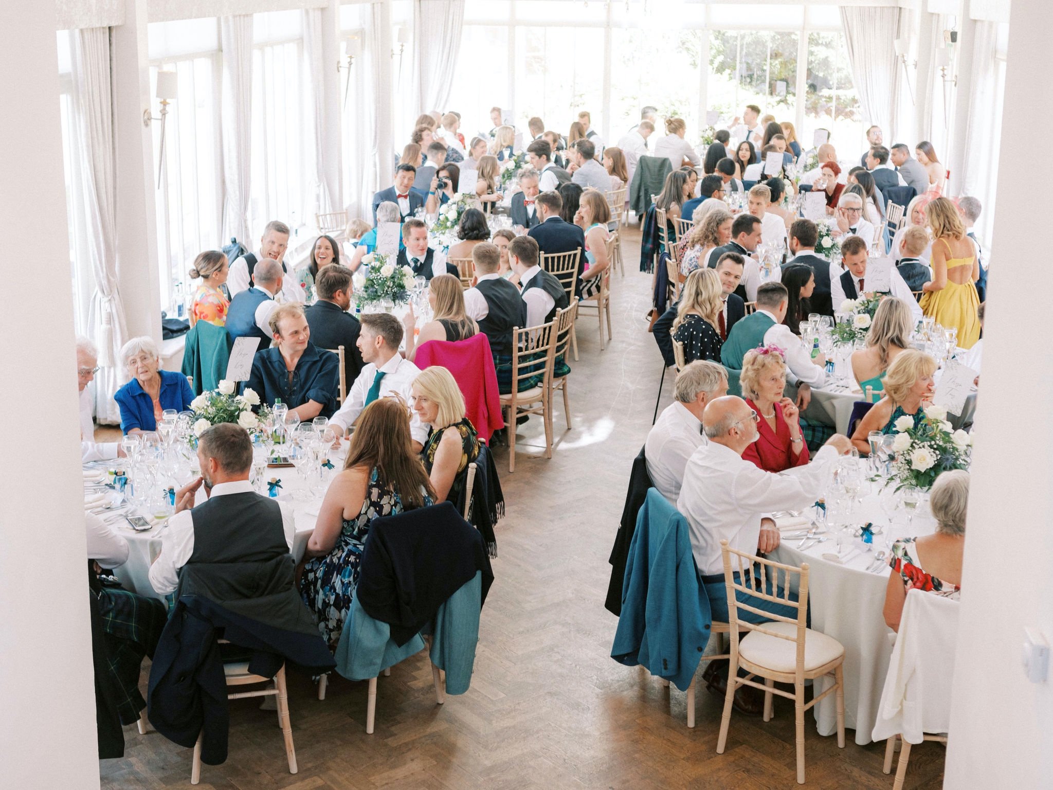 44_carlowrie castle edinburgh wedding photographer guests sat at tables for dinner.jpg