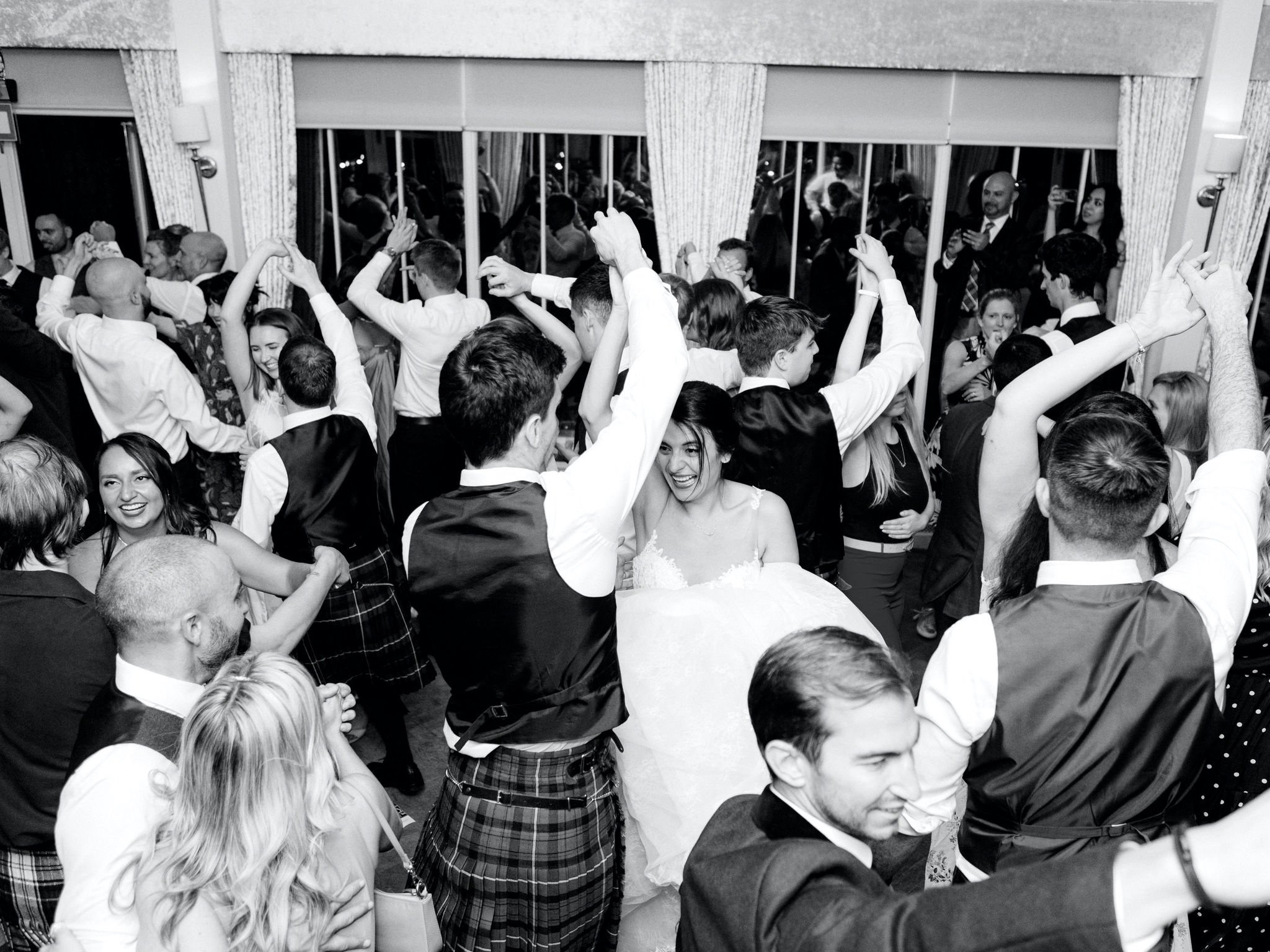 59_carlowrie castle edinburgh wedding photographer bride and groom doing a ceilidh with guests.jpg