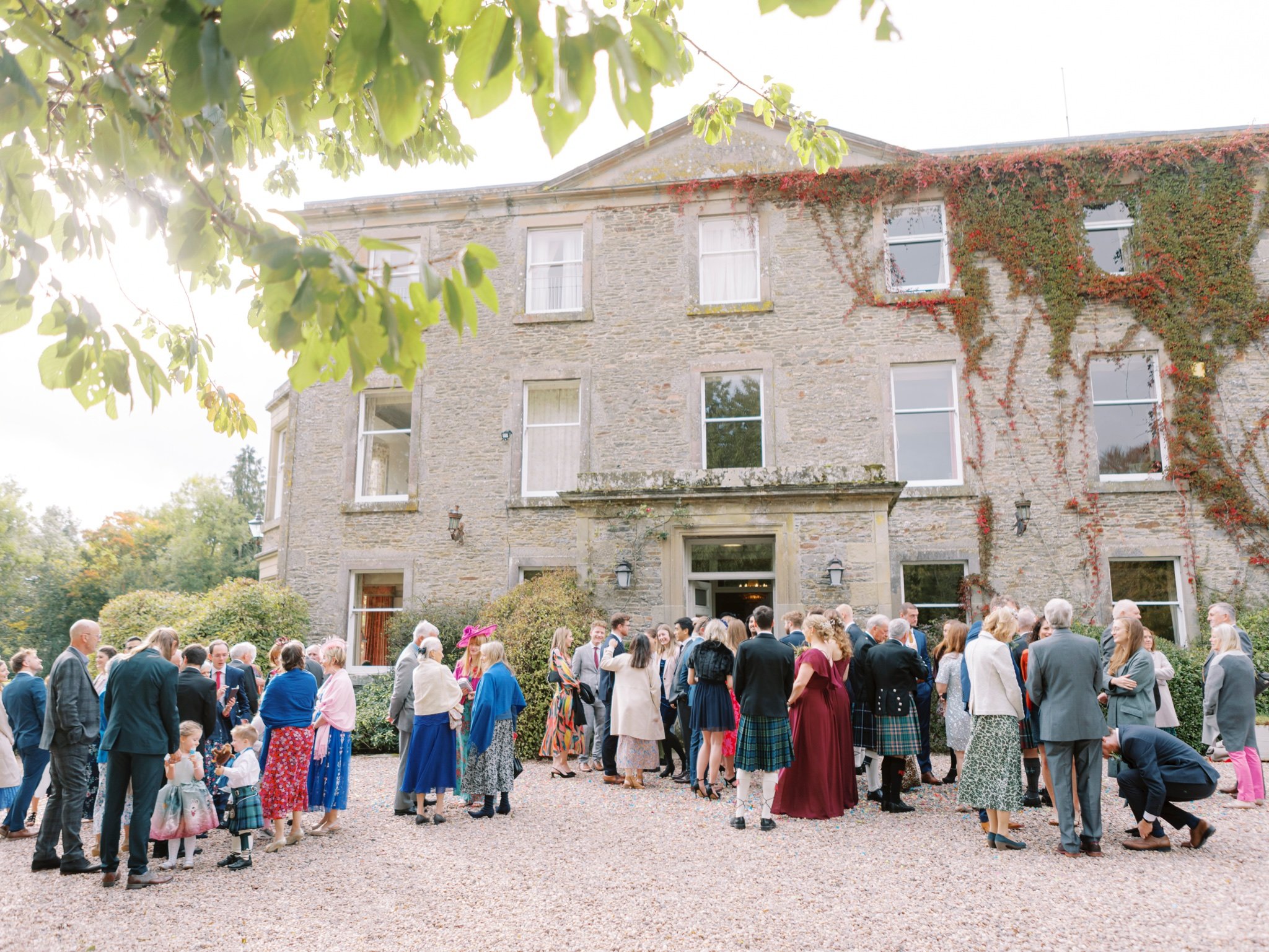 32_wedderlie house melrose scottish borders wedding photographer guests outside venue.jpg