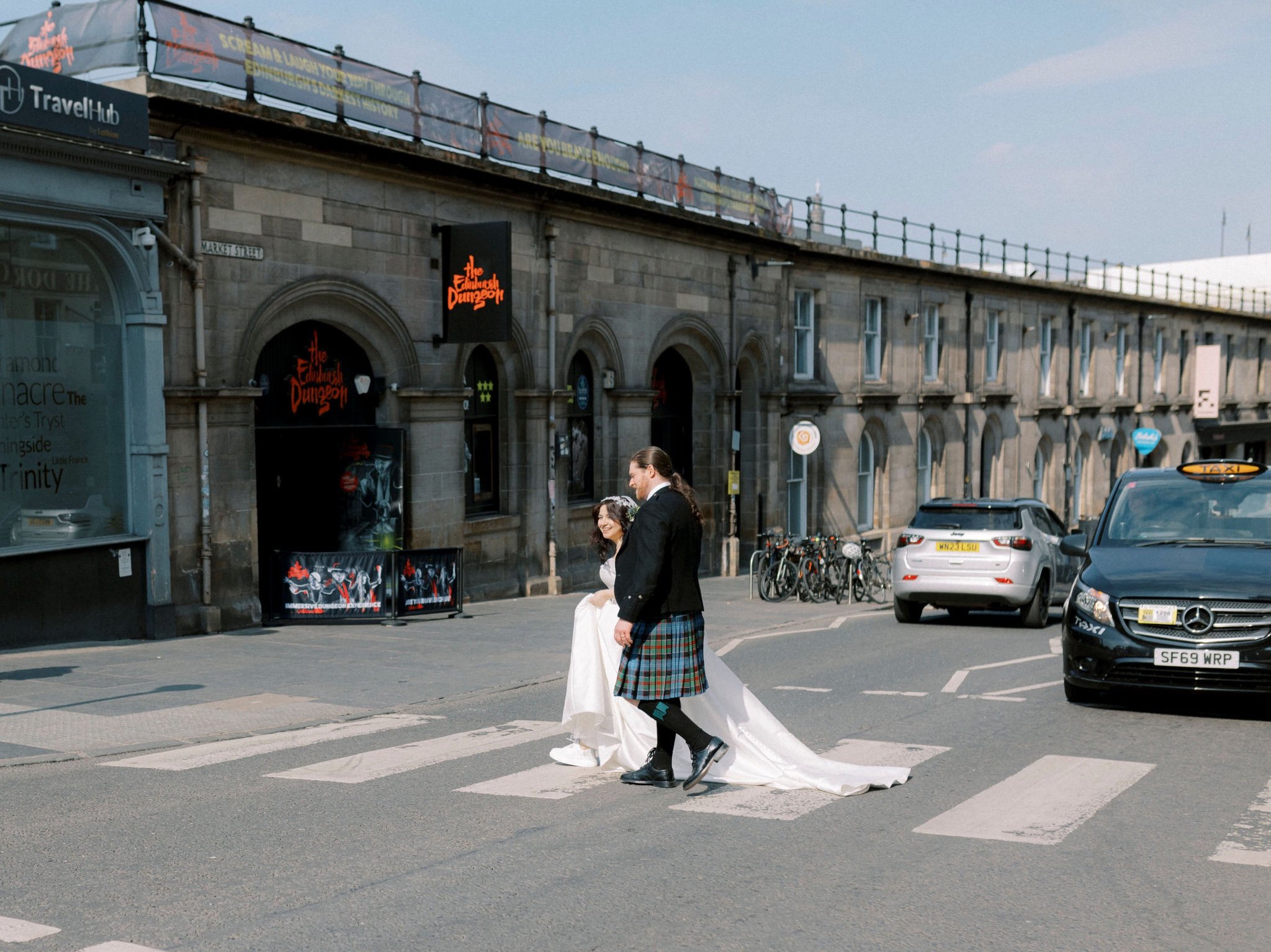 37_edinburgh-wedding-photographer-bride-groom-waking-across-zebra-crossing.jpg