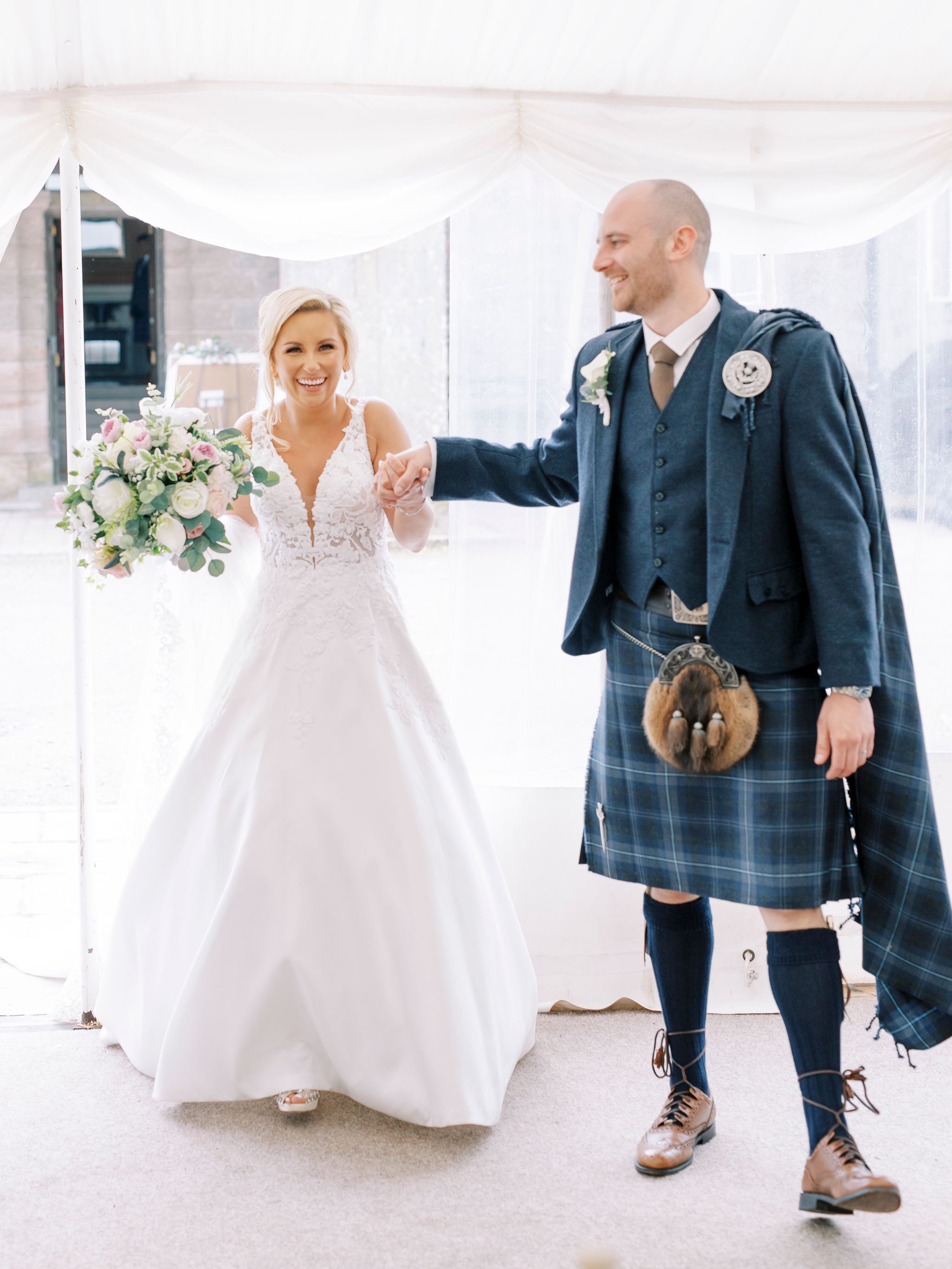 53_springkell-house-wedding-photographer-dumfries-scotland-bride-groom-enter-marquee.jpg