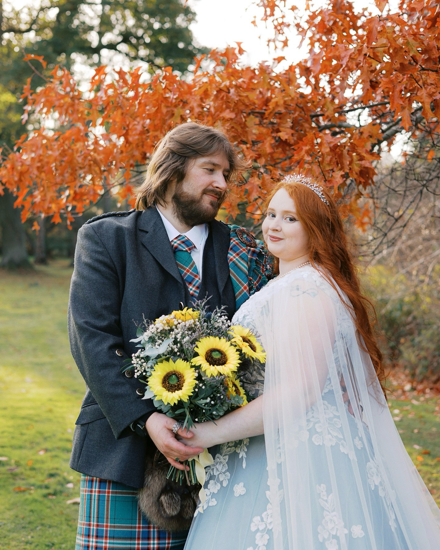 Surrounded by glowing autumn leaves, a fairytale gown dyed the softest shade of blue, and a bride whose ginger hair rivalled the golden season itself, every corner felt like a storybook come to life at Sammi and Scott&rsquo;s @carberry.weddings weddi