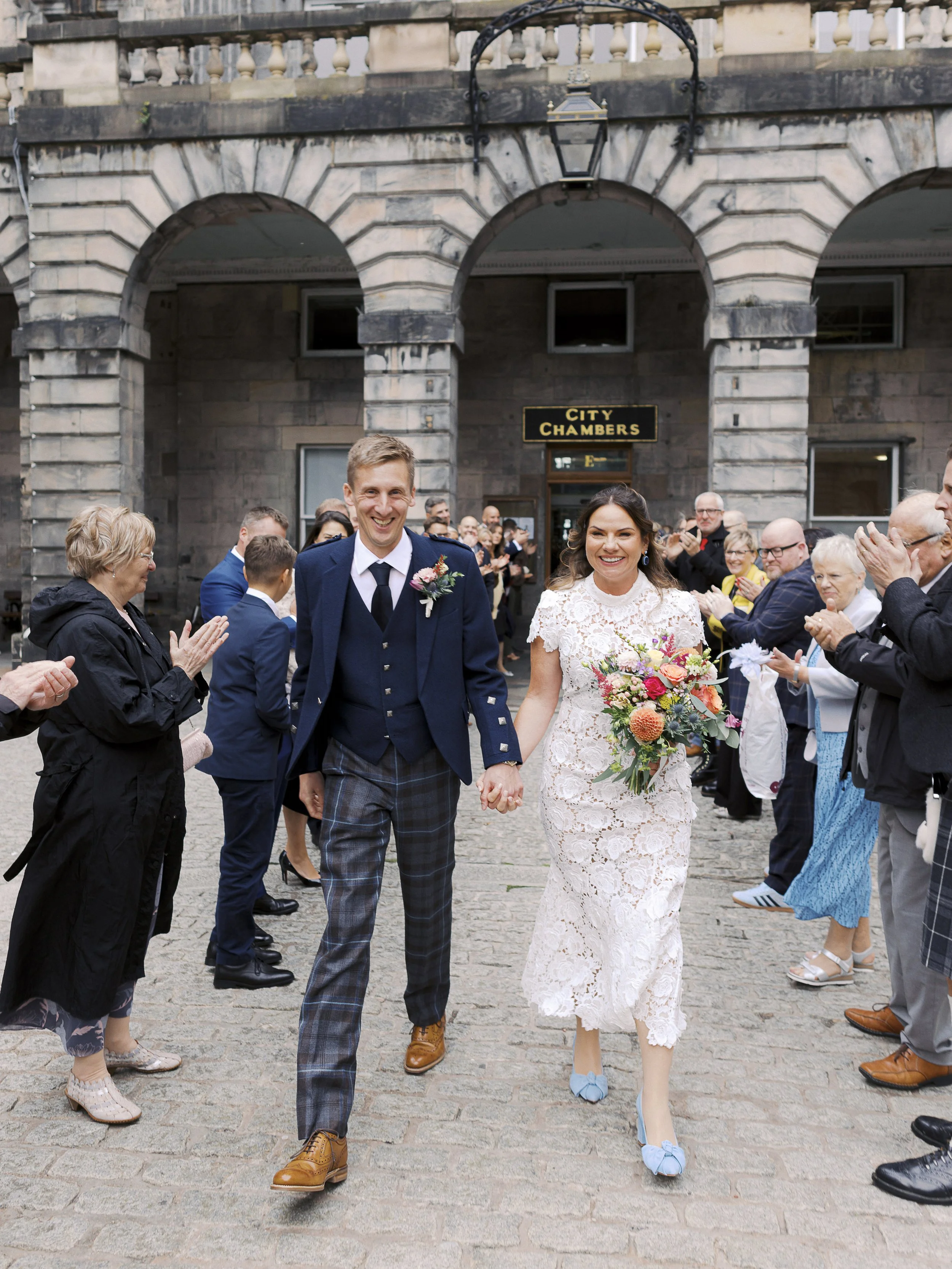 bride and groom outside edinburgh city chambers