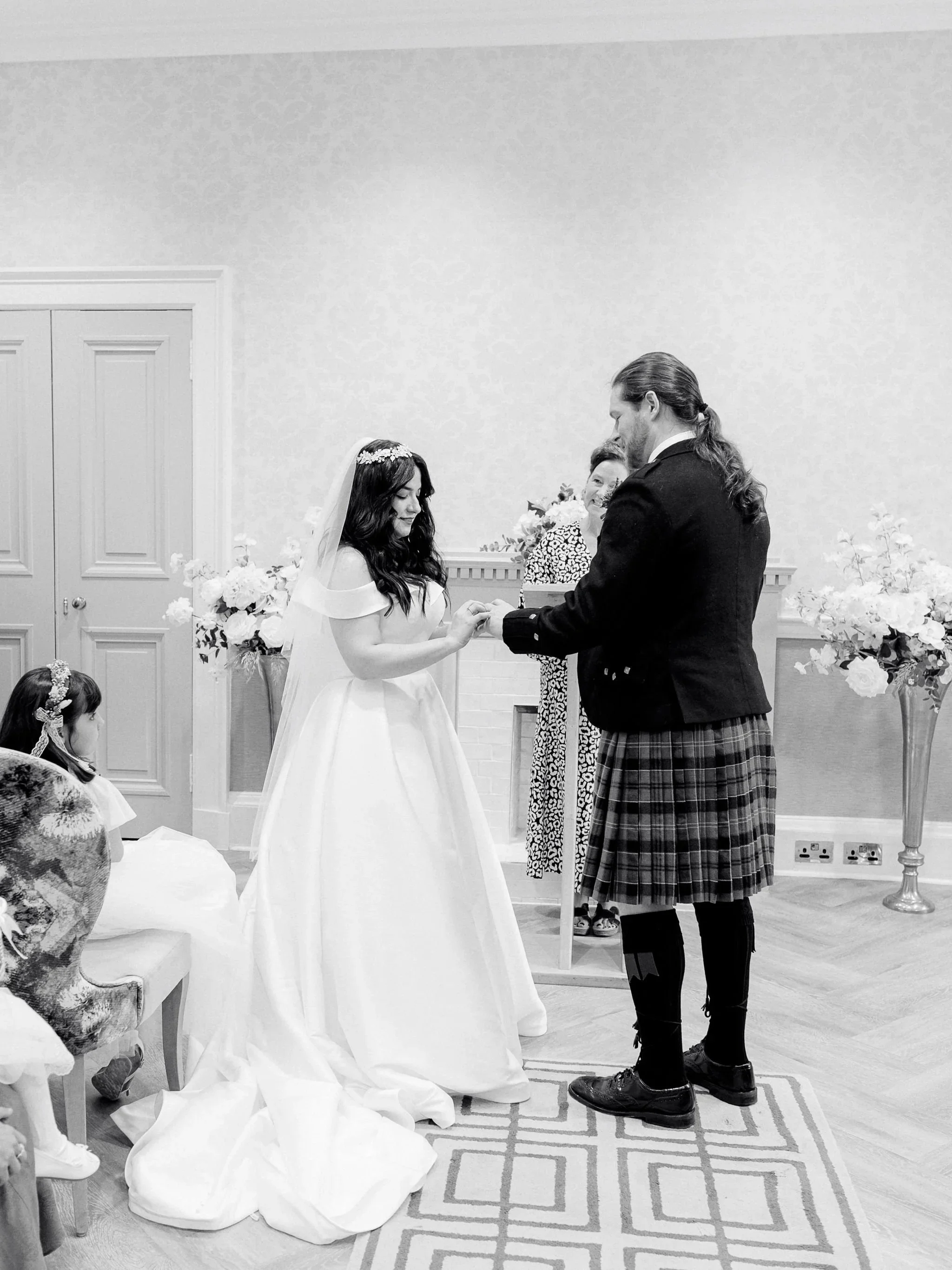 bride and groom exchanging wedding rings at edinburgh city chambers