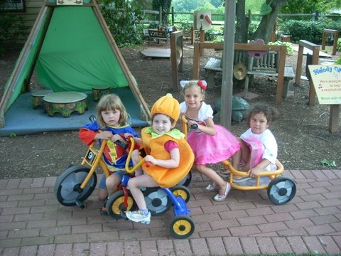 Children ride trikes at one of the four playgrounds