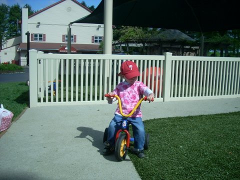 Riding a trike on the soft playground service