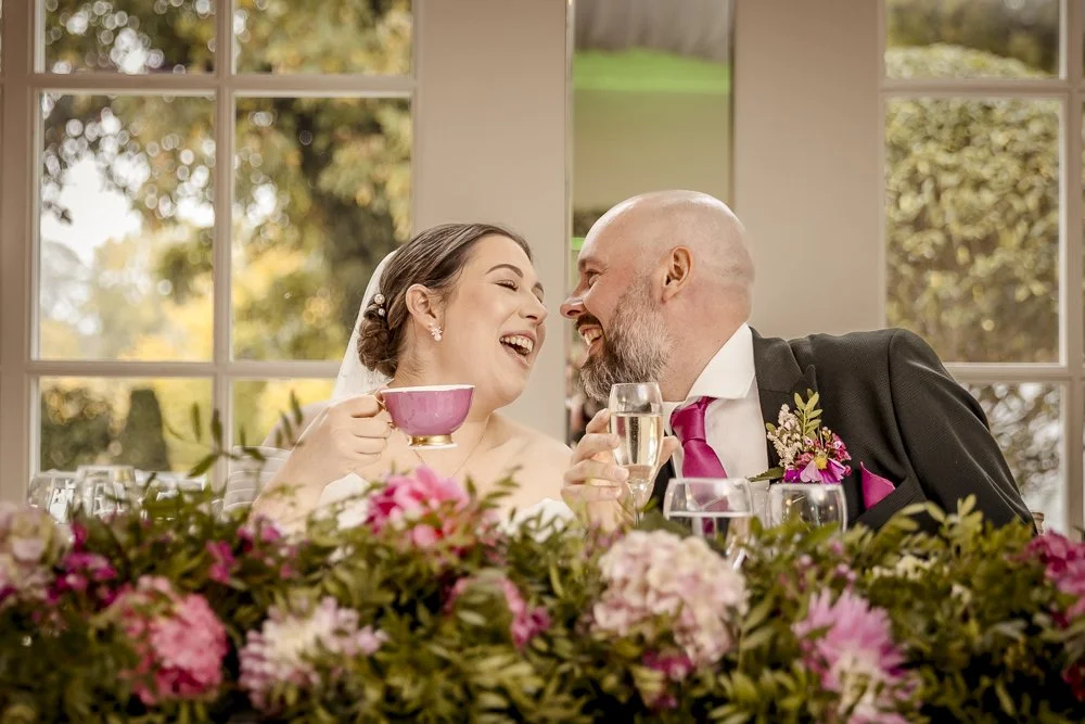 A bride and groom sing to the music before sharing a kiss during their wedding breakfast at Warwick House in Warwickshire