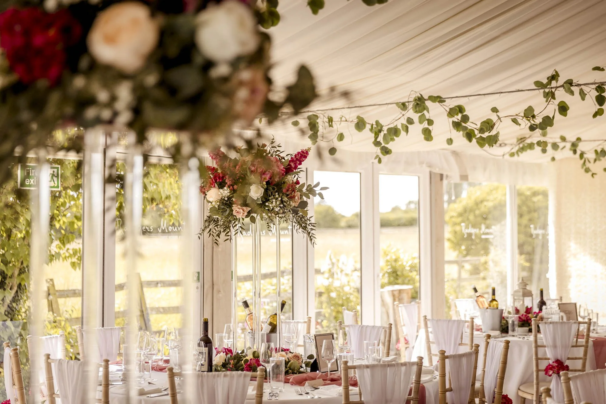 Wedding breakfast decor in pinks and greens with gorgeous light coming from the windows at this countryside Elmsthorpe venue