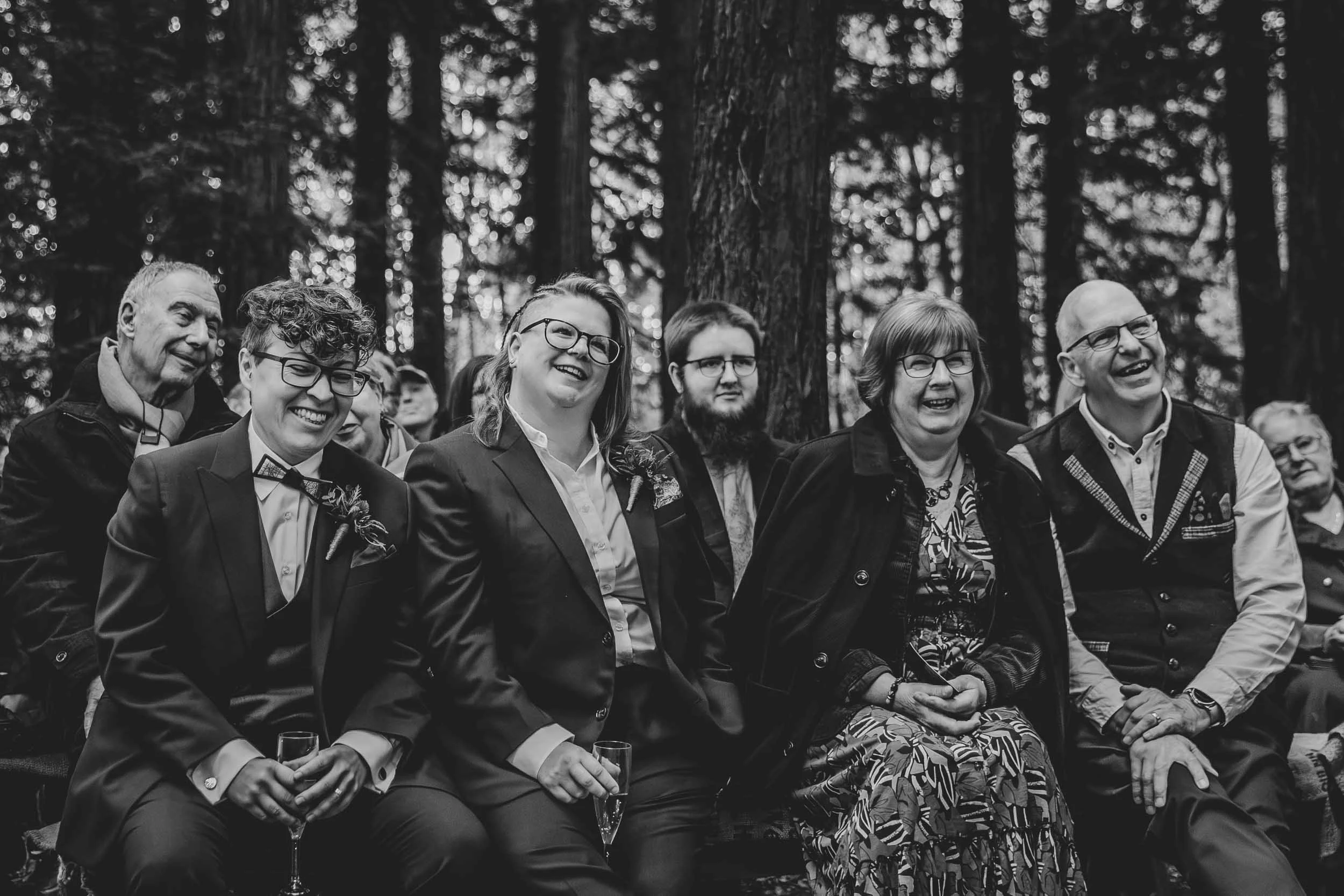 Outdoor celebrant wedding ceremony in West Sussex with guests laughing during the ceremony