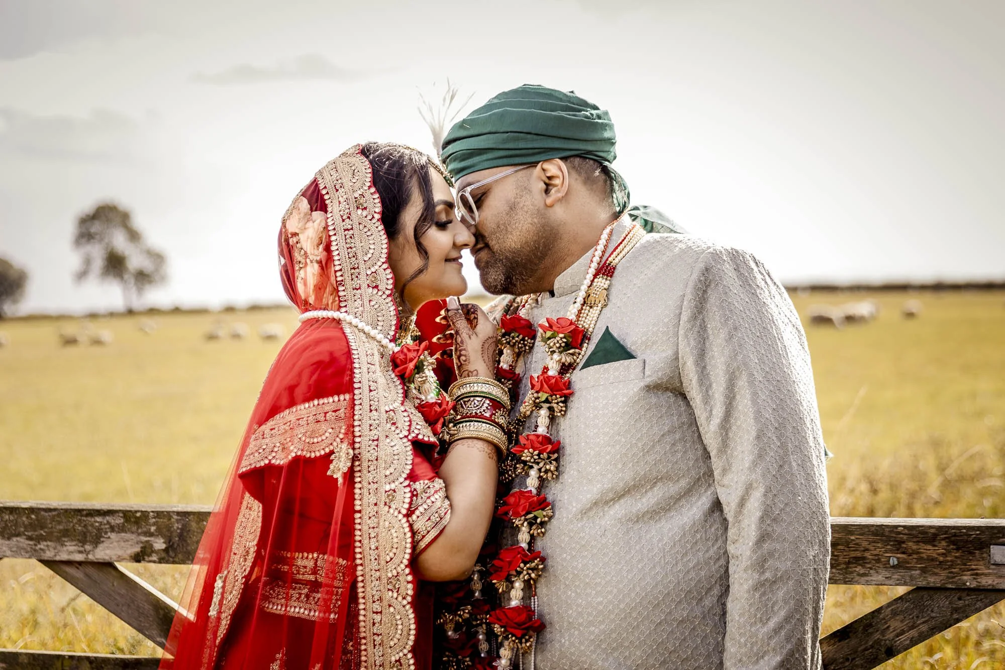 Hindu couple sharing a romantic moment in the Leicestershire countryside at wedding venue Bridge House Barn in Kibworth