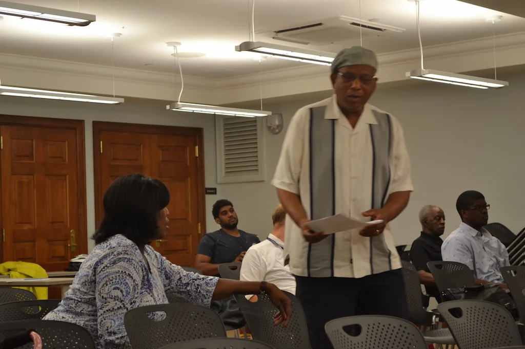 Commissioner Uqdah, talking with Lenore, a resident interested in St. Gabriel's church.