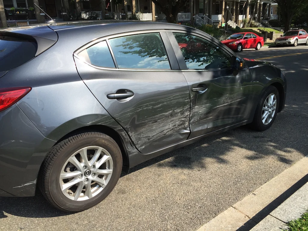 Damage to the Mazda that was traveling southbound on Kansas Avenue NW.