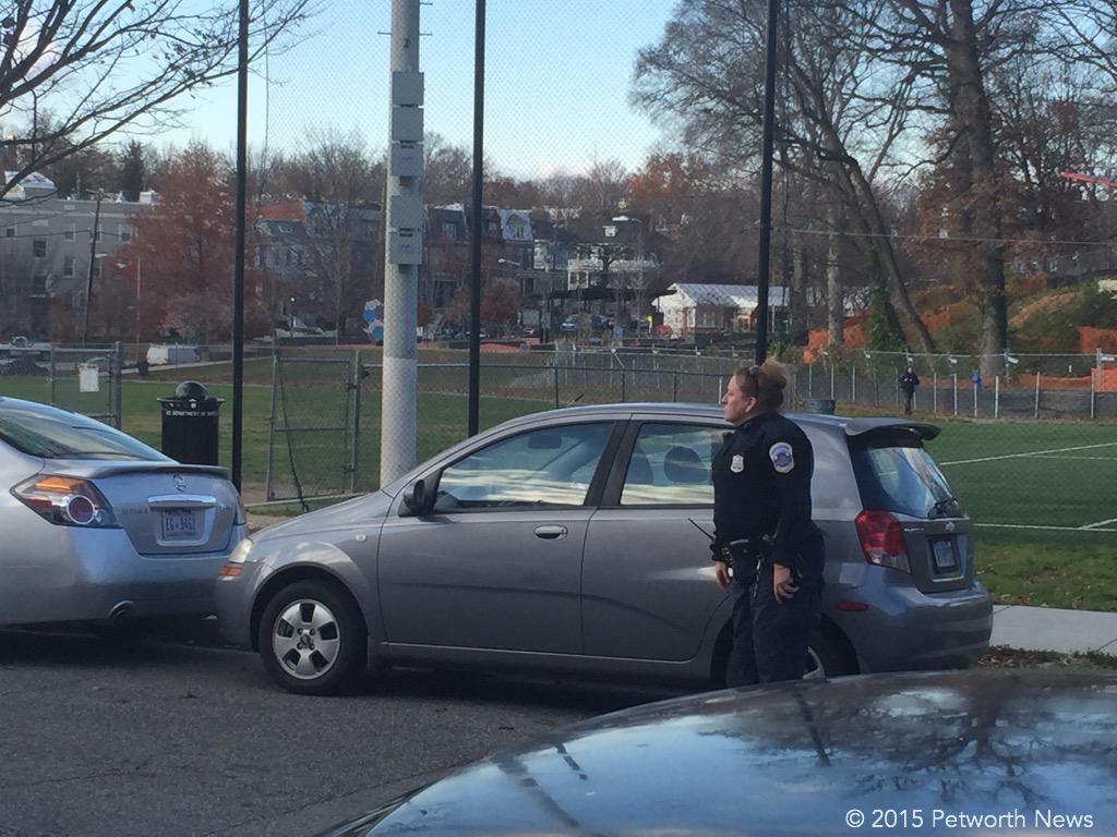 An MPD officer shooing away double-parkers on Thursday, Dec 3rd. 