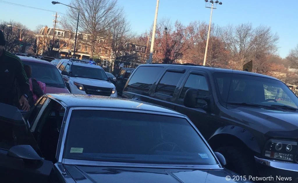 Double-parked SUV on the right, MPD SUV behind it.