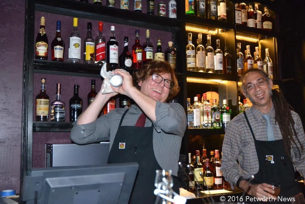 Bryan and Calvin mixed up drinks to order behind the bar.
