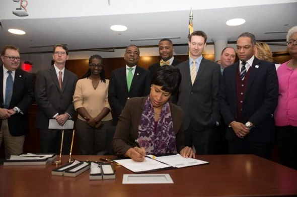 Mayor Bowser signing the security camera law into effect (photo courtesy DC Mayor's office)