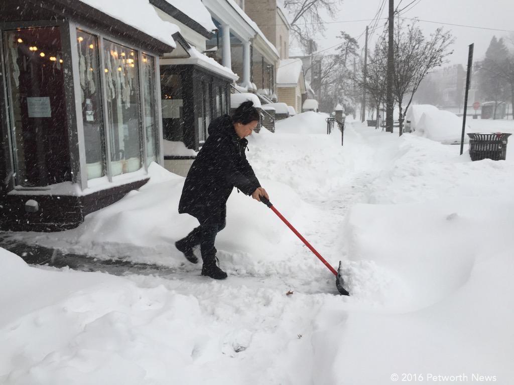  Kera Carpenter, owner of Domku, out cleaning the sidewalk 