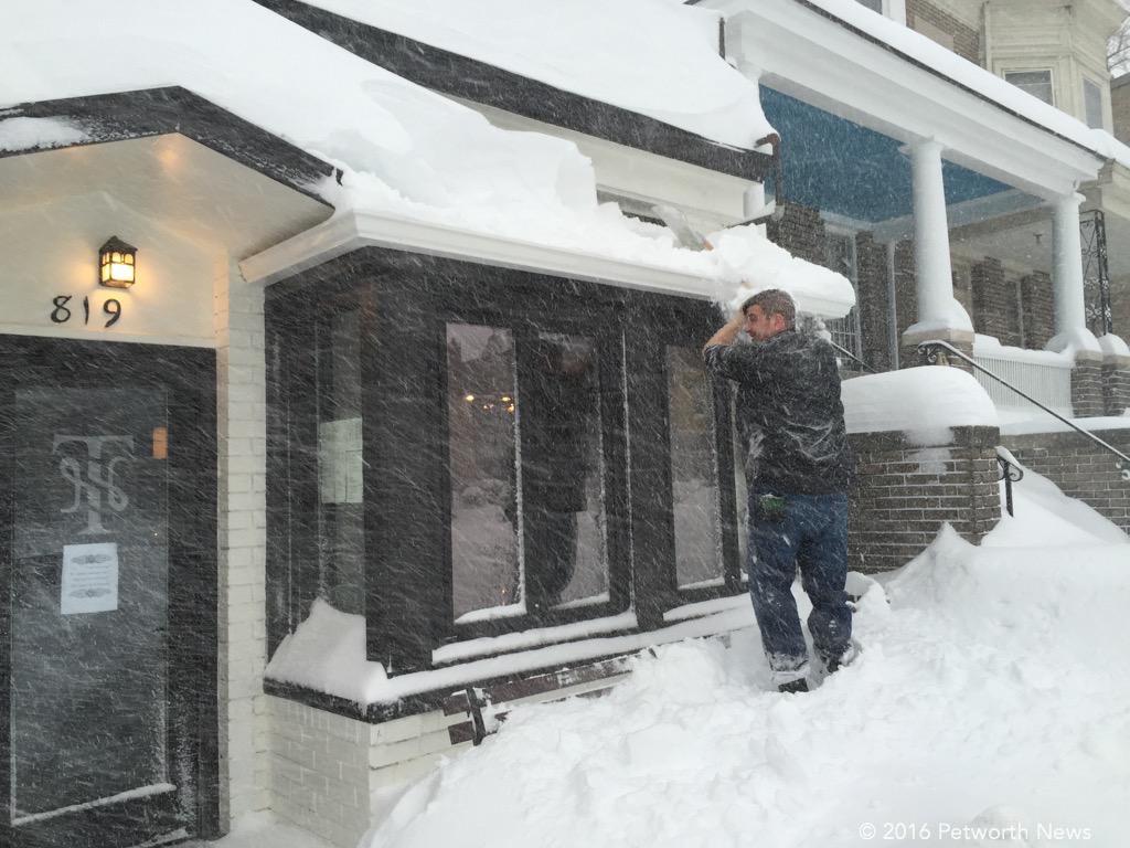  Burke Podany from Twisted Horn, cleaning the awning (they are open all weekend until 1:30am) 