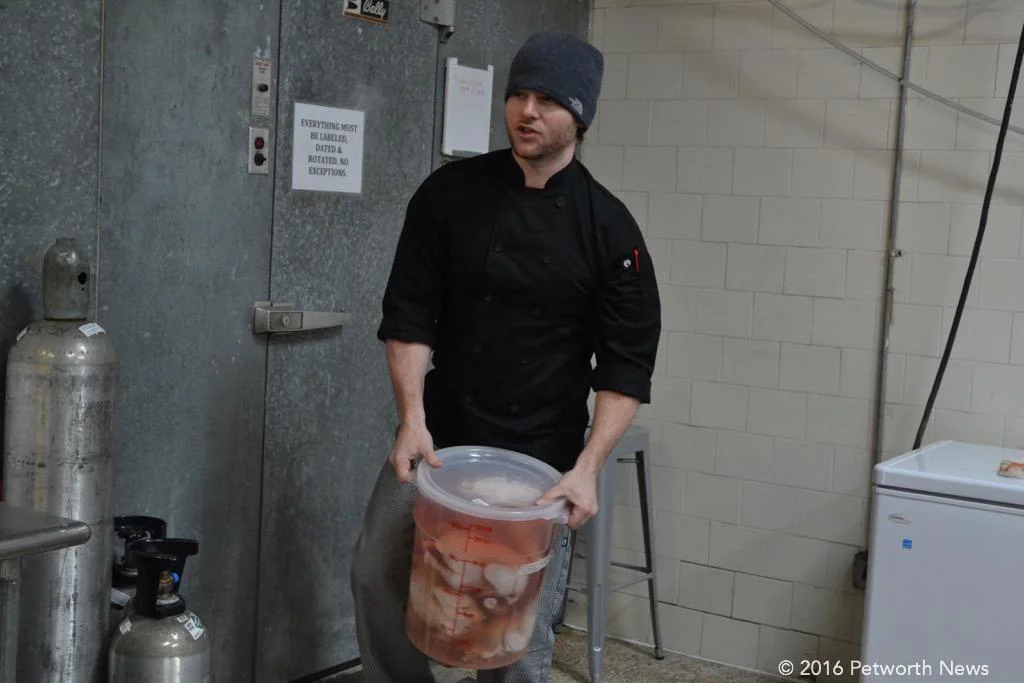 That's a lot of chicken in Alex McCoy's hands, and only one of many containers that he pulled out of the chiller for that evening's dinner.