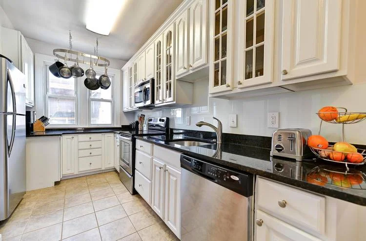 A large kitchen offers stainless steel appliances and granite countertops.