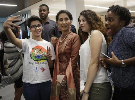 From left, Elsi Argueta, Cindy Mayen and Michannie Grant, 12th grade students from Roosevelt Senior High School in northwest Washington, pose for a selfie with Myanmar leader Aung San Suu Kyi, second from left, following a forum Thursday, Sept. 15, 2016. ( AP Photo/Manuel Balce Ceneta )