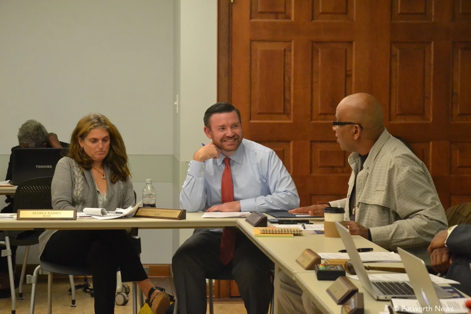 Commissioner Hayworth laughing with Commissioner Uqdah