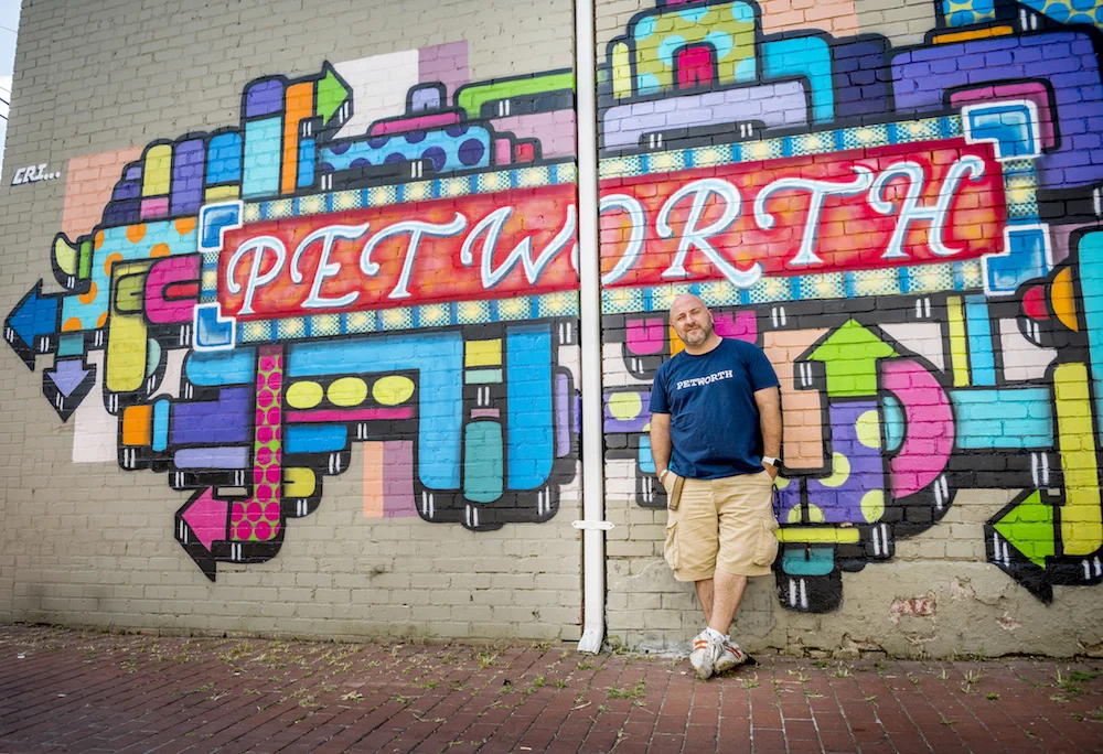 Drew doing the old school cool pose at the Petworth mural (Photo: Jason Hornick /Washington Post)