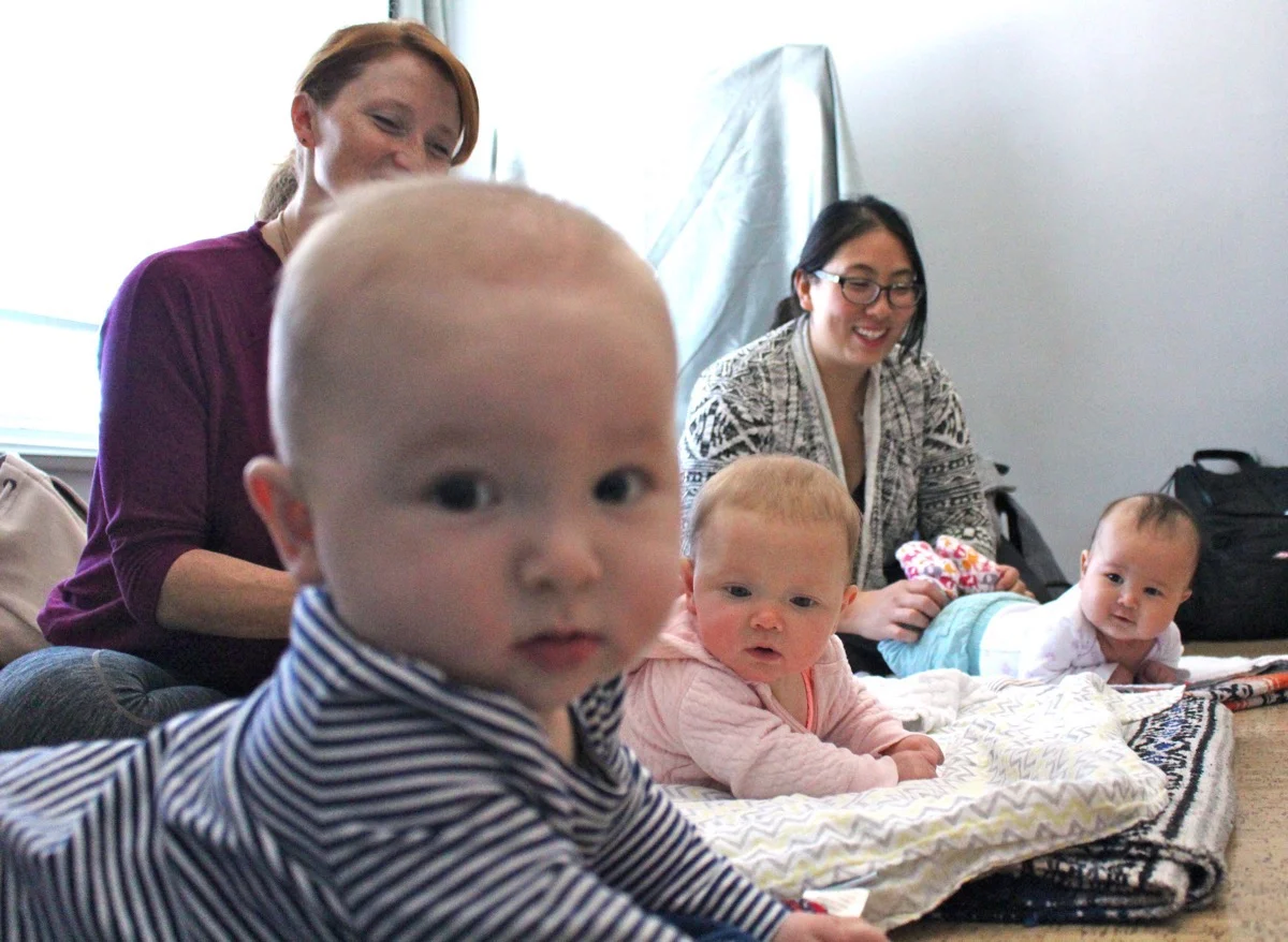 Babies get some tummy time in yoga class. From front to back: Elizabeth Chu, Jacqueline Ward and her daughter, and Jinny Choi and her daughter, Lia Patterson.