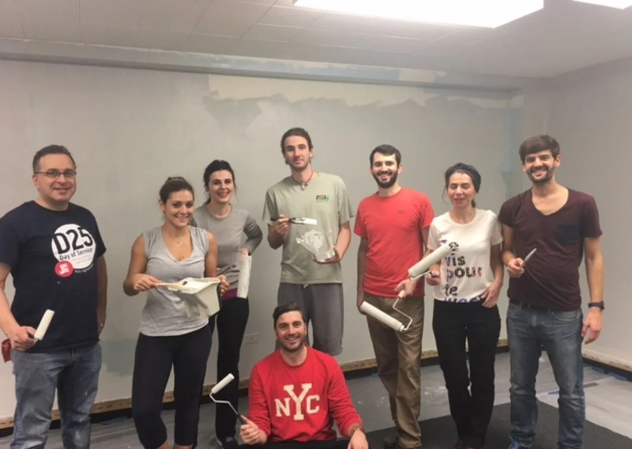 Volunteers, including Ambassador from the Republic of Kosovo Vlora Çitaku, prepare DC Community Carrot offices. (photo: David Sheon)
